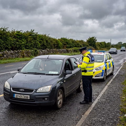 Garda officer with ANPR device stops driver with expired NCT at roadside Ireland 2026